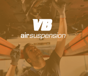 auto technician working under car