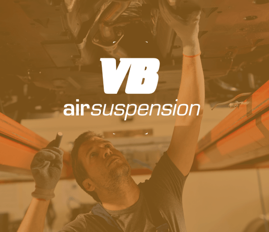 auto technician working under car